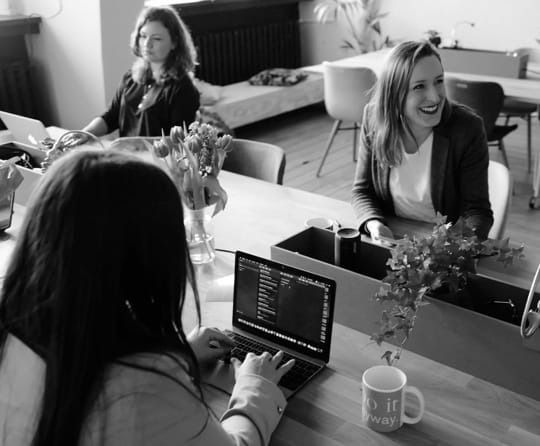 Image of ladies in office using laptops