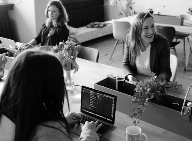 Image of ladies in office using laptops